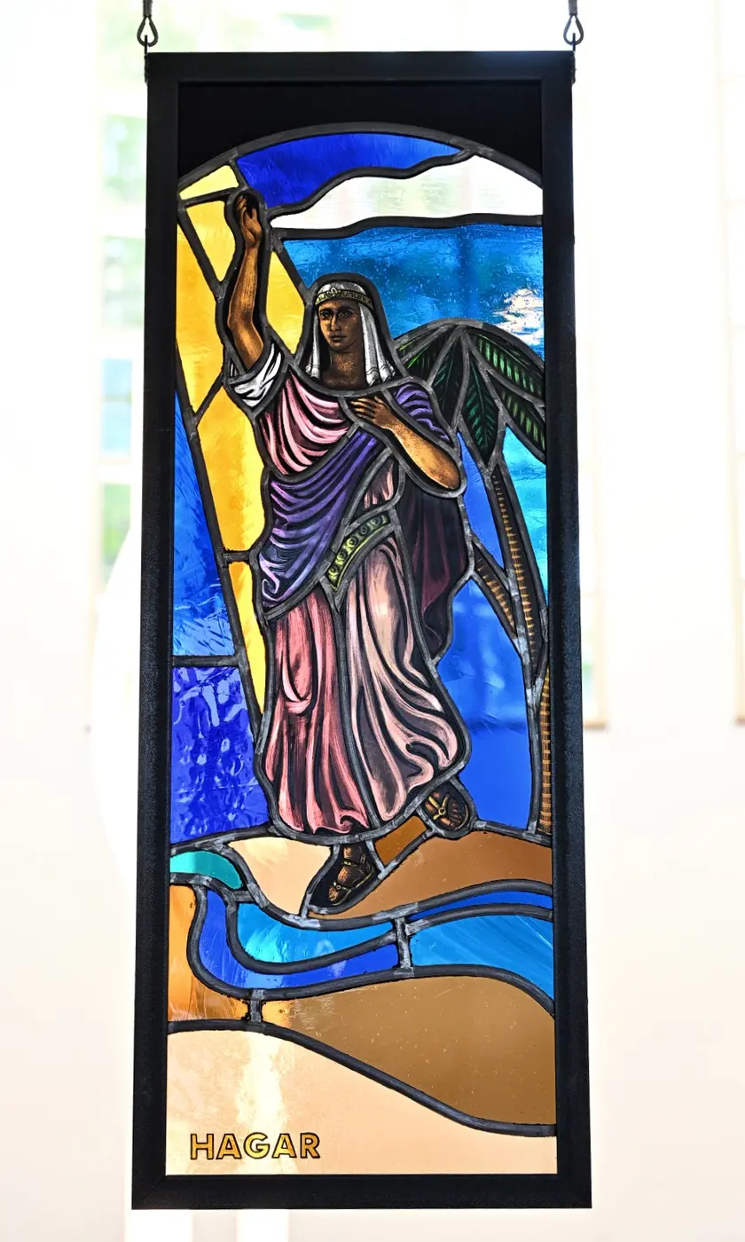 A stained-glass portrait of Hagar standing beneath the sun in the wilderness