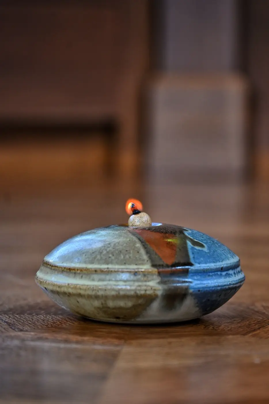 A small ceramic oil lamp burning in a quiet sanctuary